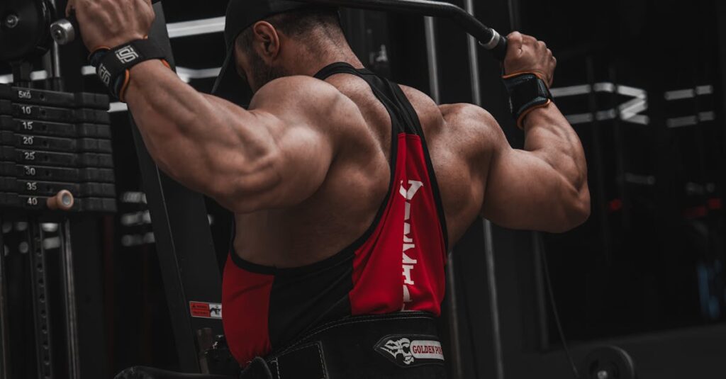 A muscular man doing lat pulldown exercise on a gym machine.